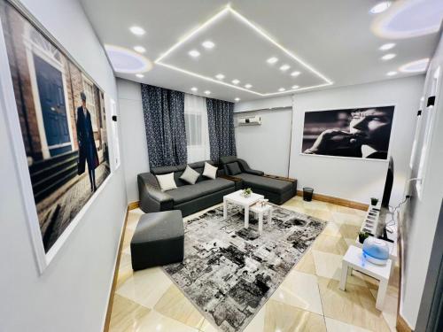 a living room with a couch and a table at شقة فندقية بالزمالك غرفتين نوم و حمام Zamalek in Cairo