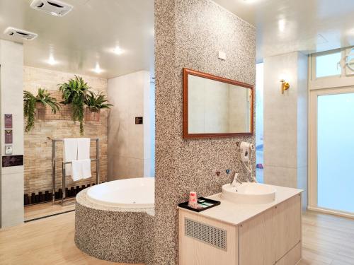 a bathroom with a tub and a sink at i Need Motel in Xinfeng
