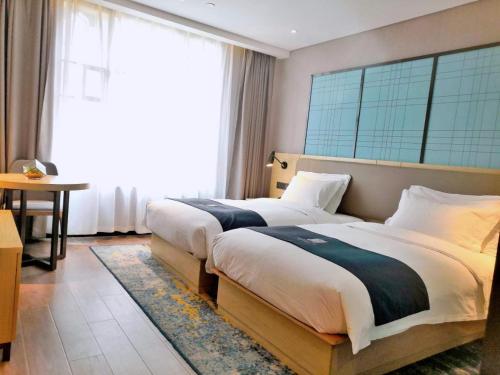 Katil atau katil-katil dalam bilik di Echarm Hotel Tongshan Niutoushan Park