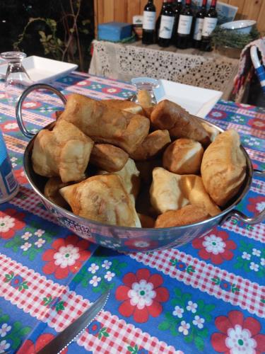 uma tigela de pão e bolos sobre uma mesa em Lodge Casa de Campo em Futaleufú