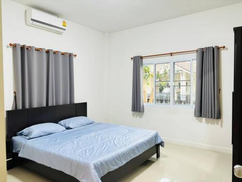 Postel nebo postele na pokoji v ubytování บ้านม่วนใจ๋ดีญ่า