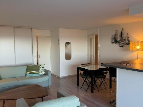 un salon avec un canapé et une table dans l'établissement Appartement 3 pièces avec accès direct plage et WiFi - FR-1-487-377, à Cabourg