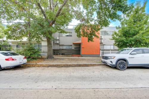 two cars parked in a parking lot in front of a building at 1 Bedroom Getaway in Houston in Houston