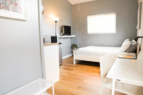 a small room with a bed and a window at Tropical Cottage in Prime Airport Area in Miami