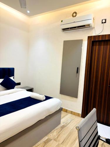 a hotel room with a bed and a air conditioner at Hotel Taj Way by Jyoti Villa in Agra