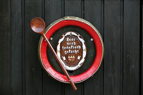 a cake in a red bowl with a spoon at Goldener Adler in Sulzheim