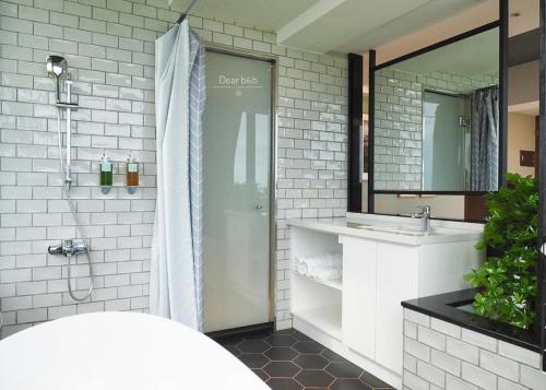 a bathroom with a shower and a sink at Wandao in Donggang