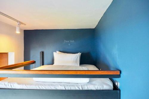 a bedroom with a blue wall with a bed at Wandao in Donggang