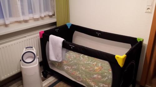 a room with a bed with a scale next to a window at Ferienwohnung Jahn in Duderstadt