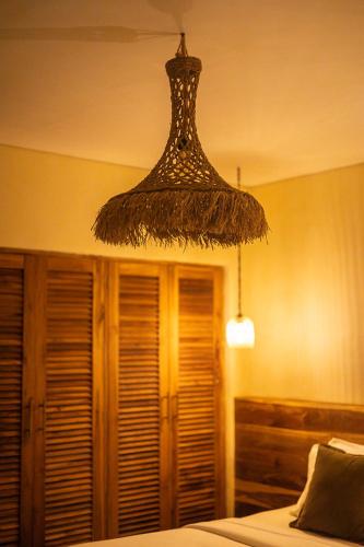 a chandelier hanging from the ceiling in a bedroom at Lulu's Villas in Uluwatu