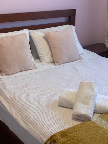 a bed with two towels on it with pillows at double room in Auckland