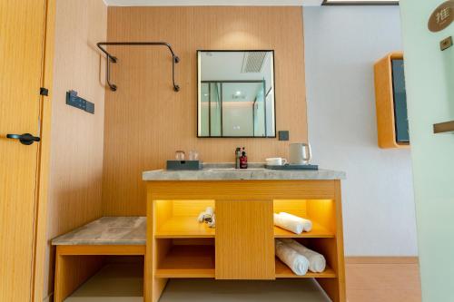 a bathroom with a sink and a mirror at 南京南站咖居精选酒店 in Nanjing
