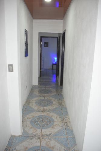 a hallway with a tile floor in a building at B&B Il Padrino in Puerto Jiménez