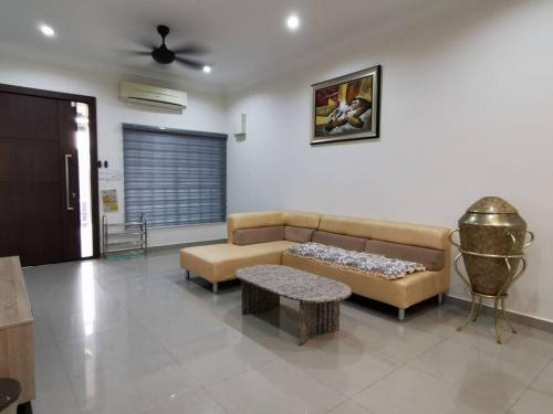 a living room with a couch and a table at Homezstay Permyjaya Miri in Miri