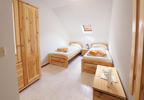 a small room with two beds and a table at Albergo Pontafel in Pontebba