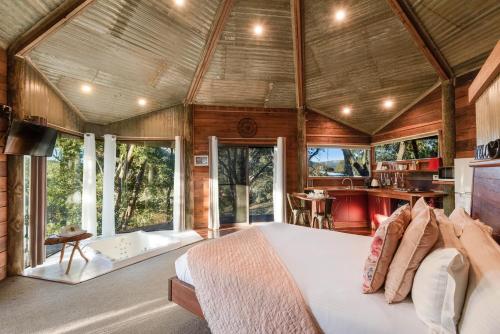 a bedroom in a tree house with a bed and a kitchen at Eagle View Escape in Rydal
