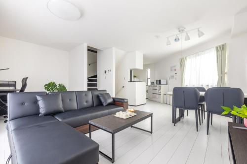 a living room with a couch and a table at 鎌倉由比ガ浜Home in Kamakura