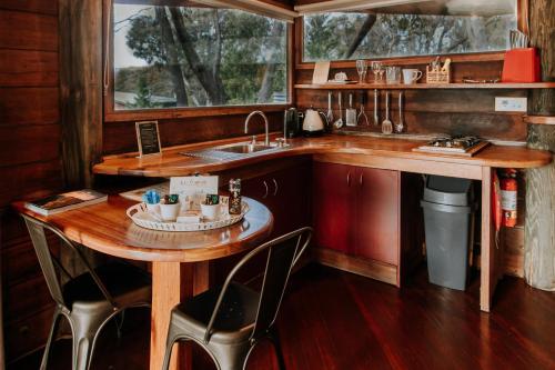 a kitchen with a wooden table and a sink at Eagle View Escape in Rydal