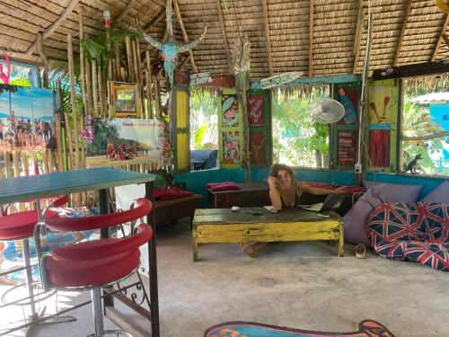 a woman sitting on a table in a room at Freedom home in Ko Chang