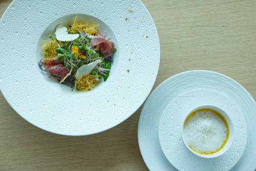 a plate of food and a cup of coffee on a table at UMITO Kamakura Koshigoe in Kamakura