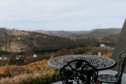 a table and chairs with a view of the mountains at Eagle View Escape in Rydal