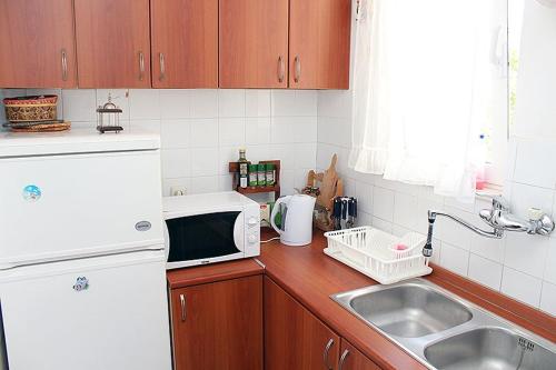 a kitchen with a sink and a microwave at Vemar Apartment - Near the beach, Private parking in Dubrovnik