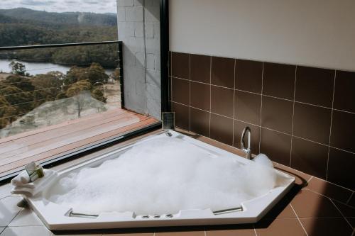 a bath tub in a bathroom with a window at Eagle View Escape in Rydal