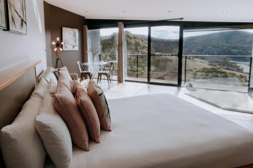 a bedroom with a bed with pillows on it at Eagle View Escape in Rydal