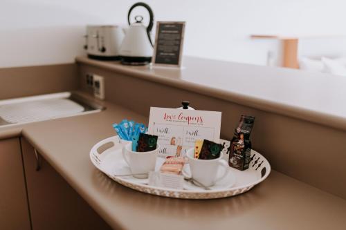 a plate with two cups and a sign on a counter at Eagle View Escape in Rydal