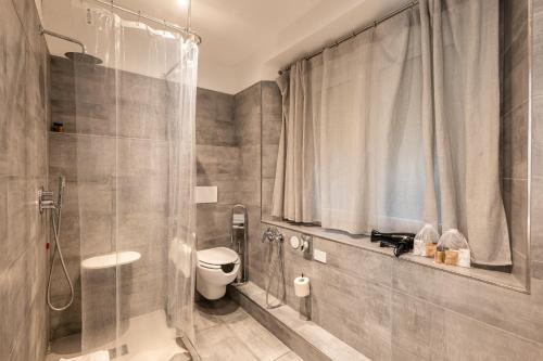 a bathroom with a shower and a toilet in it at Ai Suma Hotel in Milan