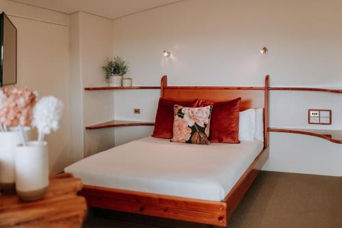 a bedroom with a bed with red pillows at Eagle View Escape in Rydal