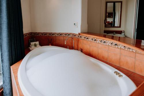 a bath tub in a bathroom with a mirror at Eagle View Escape in Rydal