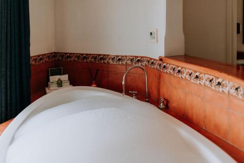 a bath tub with a faucet in a bathroom at Eagle View Escape in Rydal