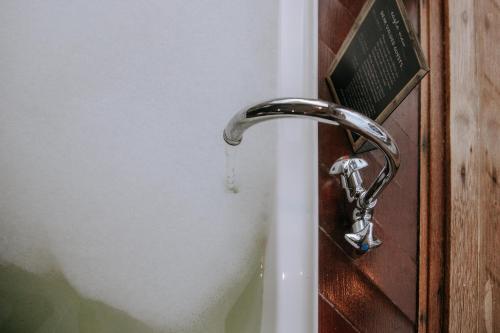 a bathroom door with a water faucet at Eagle View Escape in Rydal