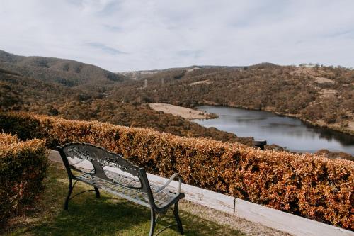 a bench sitting on a hill overlooking a lake at Eagle View Escape in Rydal
