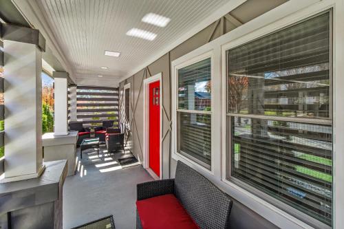 an empty room with a red door and windows at Charlotte Retreat: Luxury 4BR Heaven in Charlotte