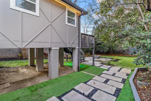 a backyard with a house with a playground at Charlotte Retreat: Luxury 4BR Heaven in Charlotte