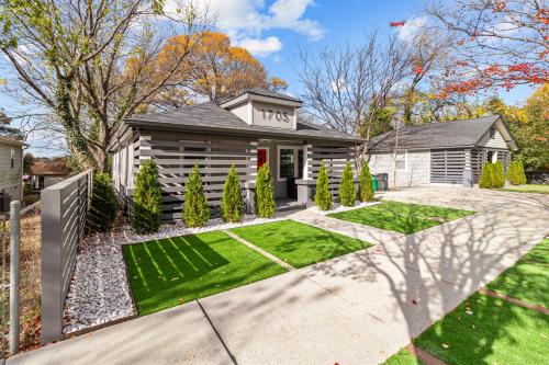 a house with a garden in front of it at Charlotte Retreat: Luxury 4BR Heaven in Charlotte