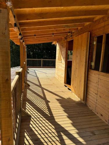 an outside porch of a wooden building with awning at La Cabaña de Blue in Guarne