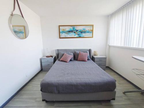 a bedroom with a bed with two pillows on it at Departamento en Paseo de la Reforma CDMX in Mexico City