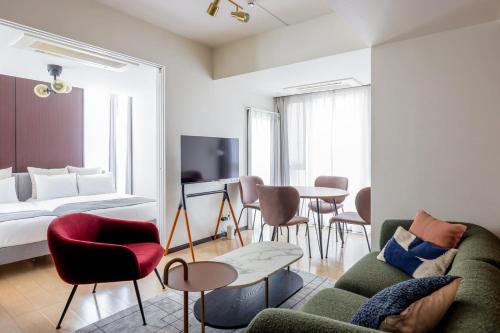 a living room with a couch and a table at Las Pacios Azabu Kougai-cho Residence in Tokyo