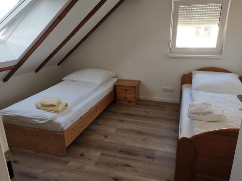 a bedroom with two beds and a window at Pension Christina in Niederwerrn