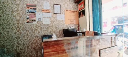 a bar in a restaurant with a desk and chairs at Hotel Ananya Inn in Varanasi
