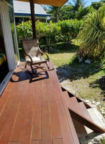 a bench sitting on the porch of a house at Ocean Side Bungalow in Teavaro