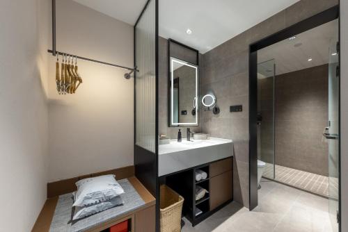 a bathroom with a sink and a shower at Atour Hotel Dali Erhai International Convention and Exhibition Center in Dali