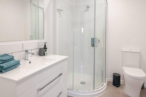 a bathroom with a shower and a sink and a toilet at On The Beach in Napier