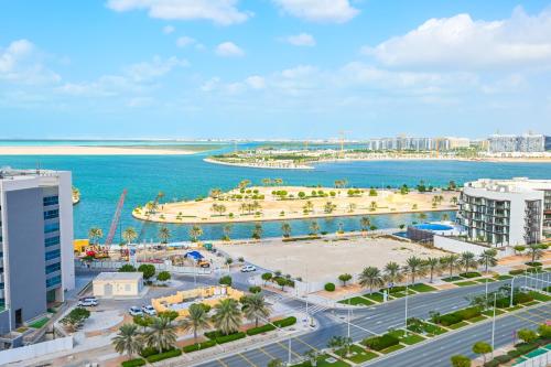 an aerial view of a city and the ocean at Rooftop Pool - Designer's Choice - Full Canal View in Abu Dhabi