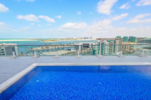 a swimming pool on the roof of a building at Rooftop Pool - Designer's Choice - Full Canal View in Abu Dhabi