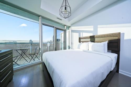 a bedroom with a large bed and a balcony at The York I in Toronto