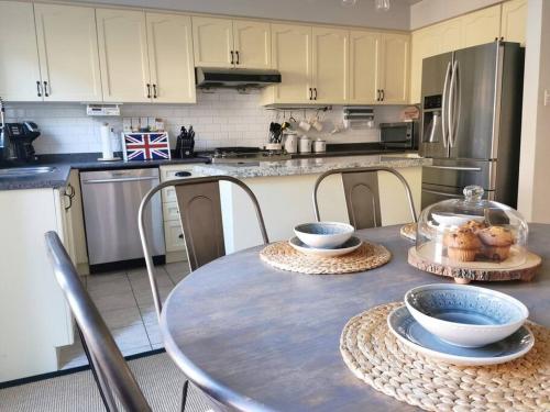 a kitchen with a table with bowls on it at LakePark Artsy 3 bedroom Townhouse 1 Parking in Toronto
